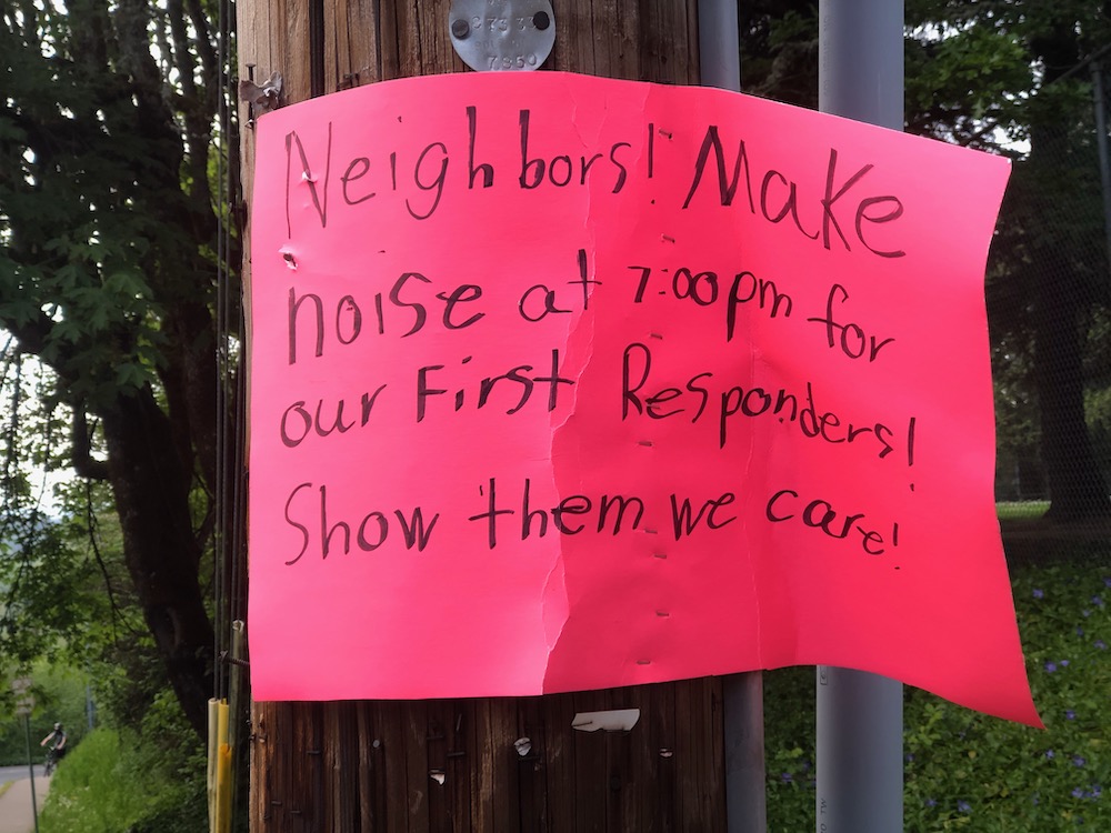 sign posted on a telephone pole asking for people to make noise at 7pm to show appreciation for healthcare workers