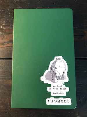 new green moleskine with a smolrobots sticker